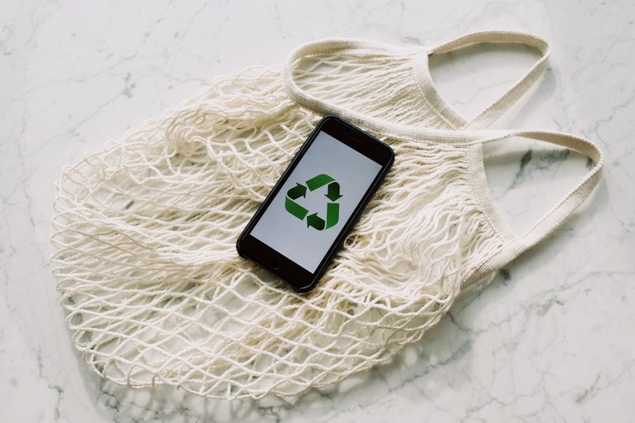 Mobile phone with green recycling sign and mesh bag 3850512